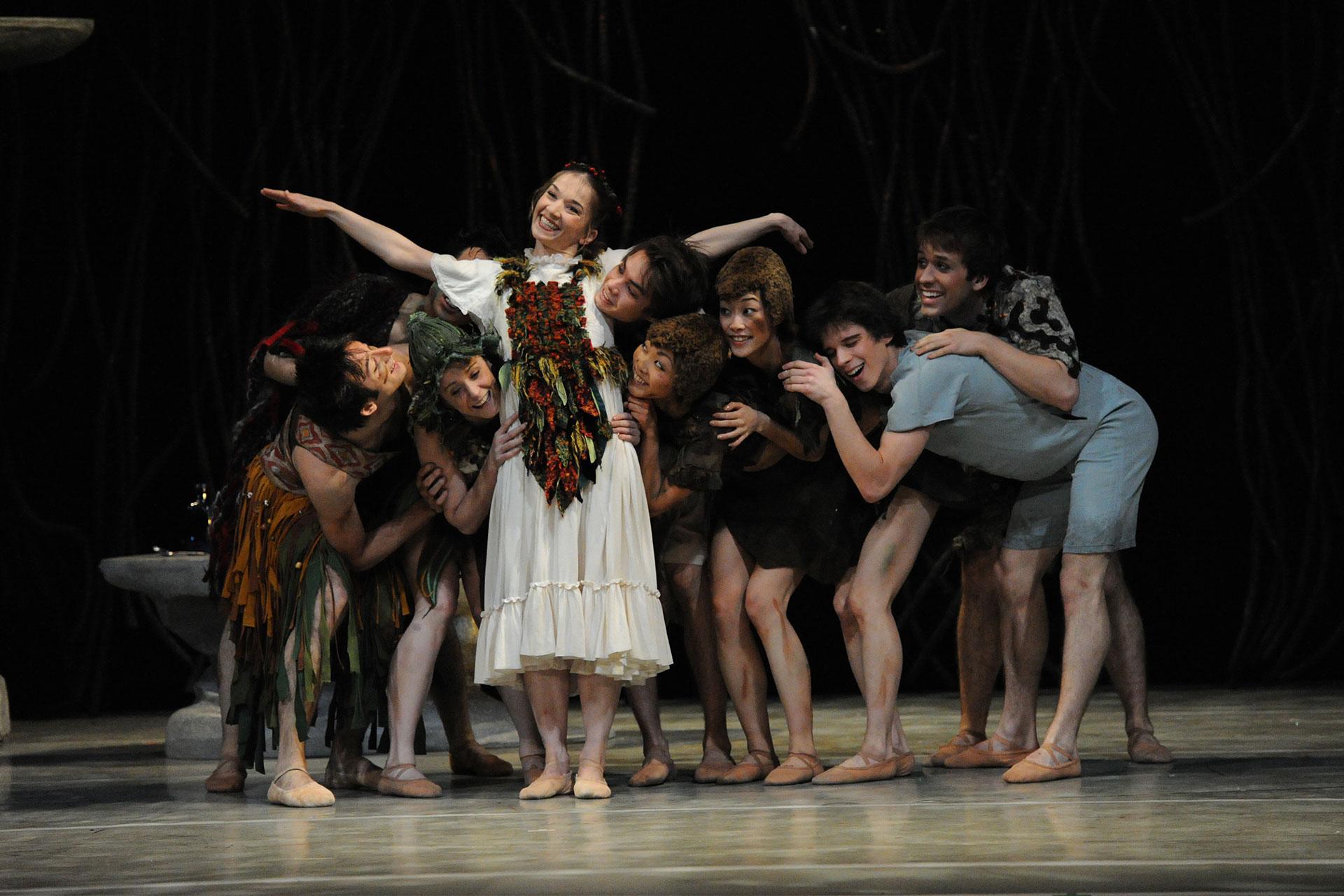 The Lost Boys look to Wendy as their surrogate mother as she hugs them all