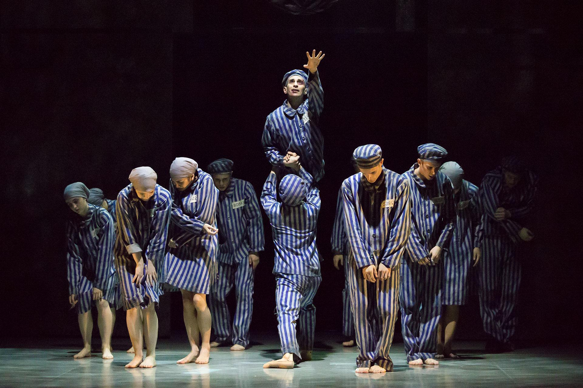 A boy reaches out as people are gathered