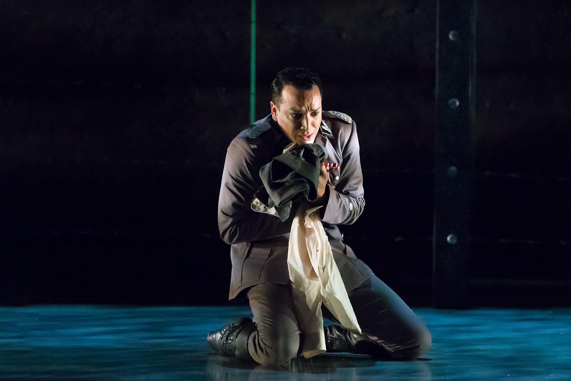 The Commandant breaks down, holding his son's discarded clothes when he learns the truth