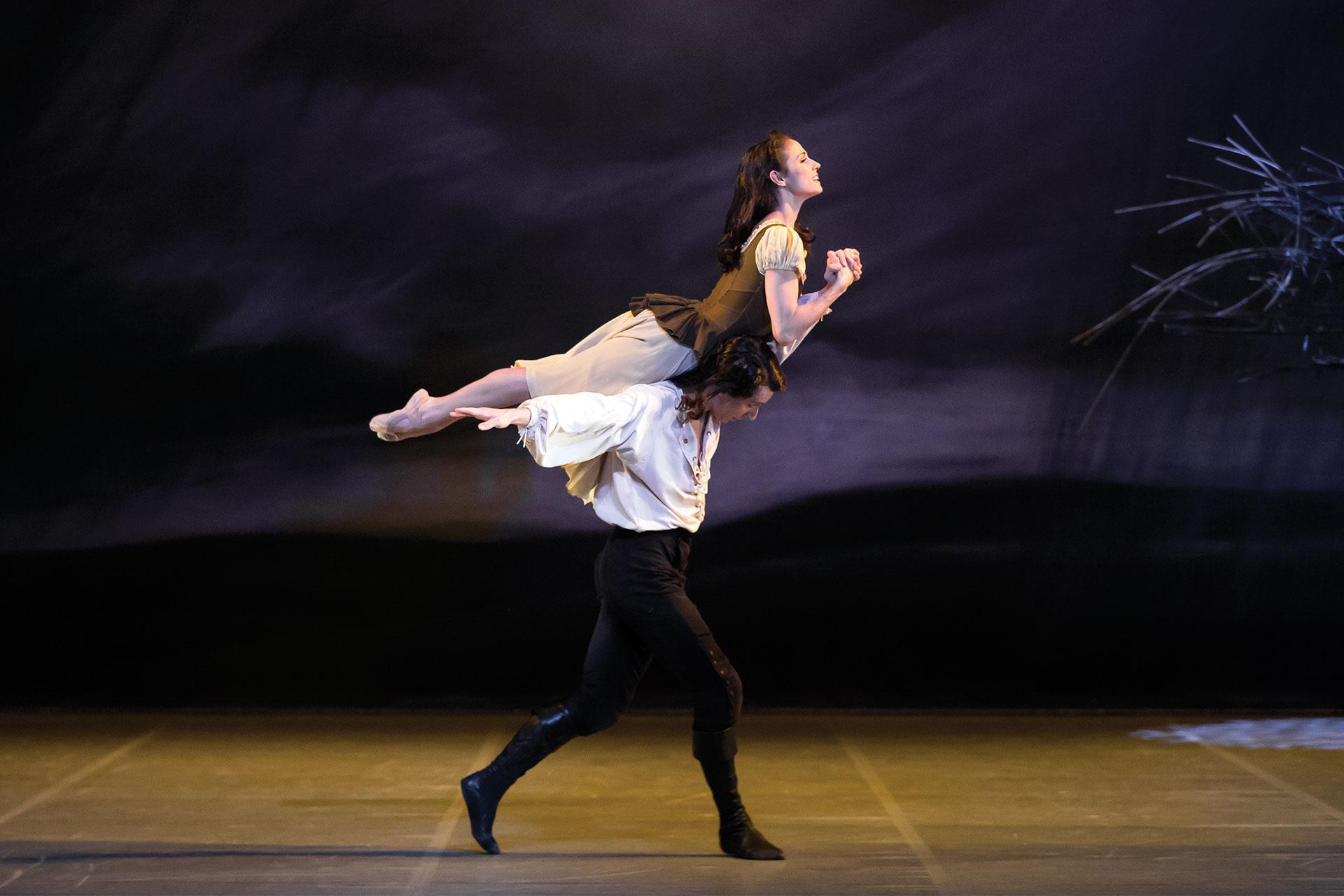 Heathcliff carries Cathy on his back through their old playing fields on the moors