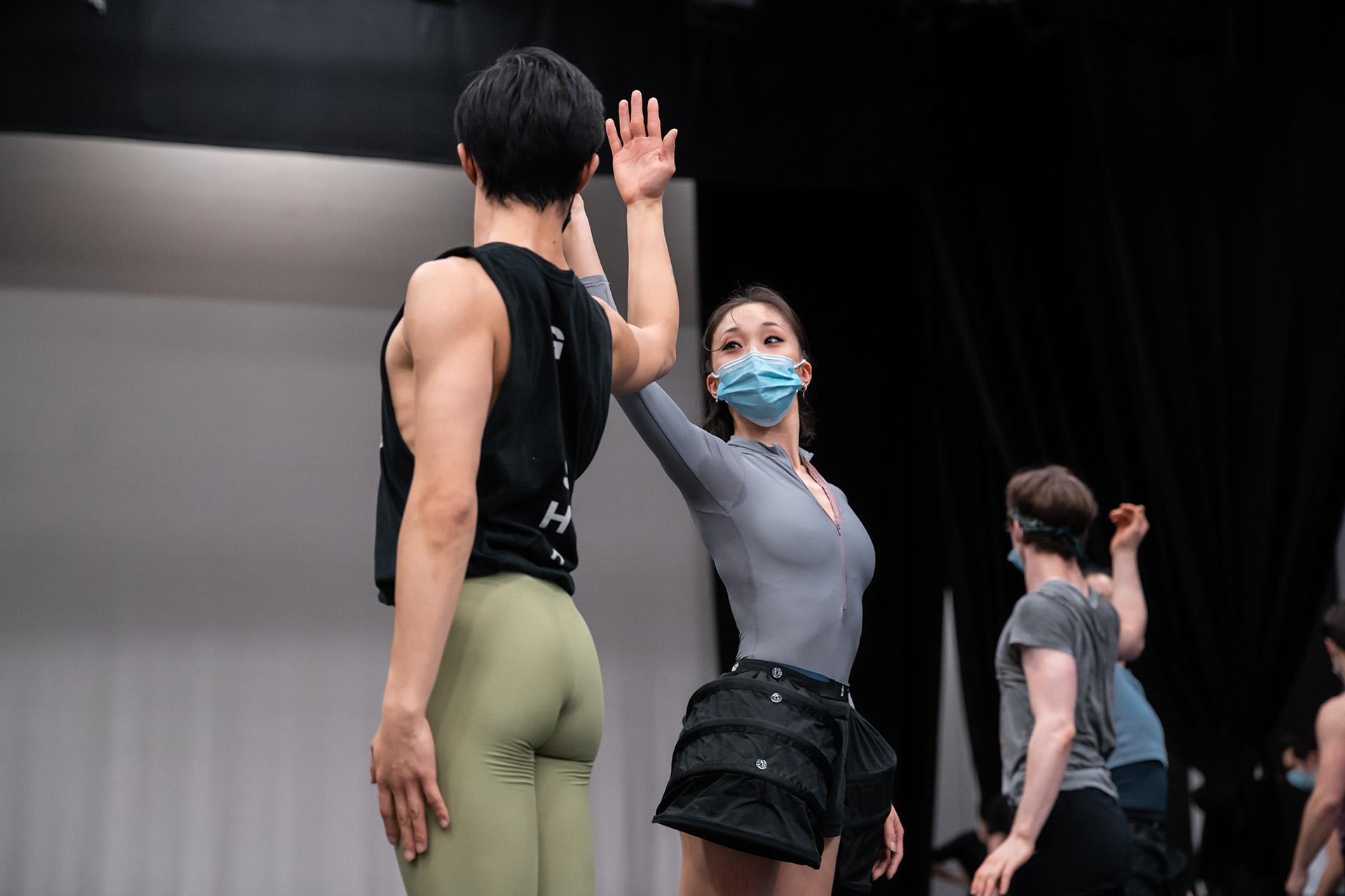 Dancers holding their arms against each other during rehearsals