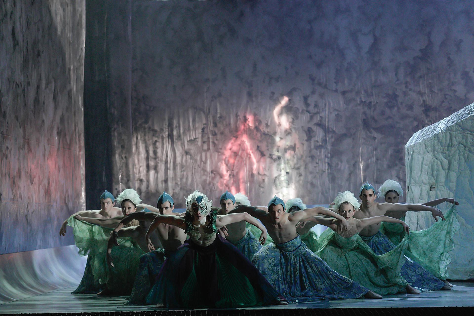 Lry and dancers representing the sea bend forward and look menacing with their arms lifted to the side