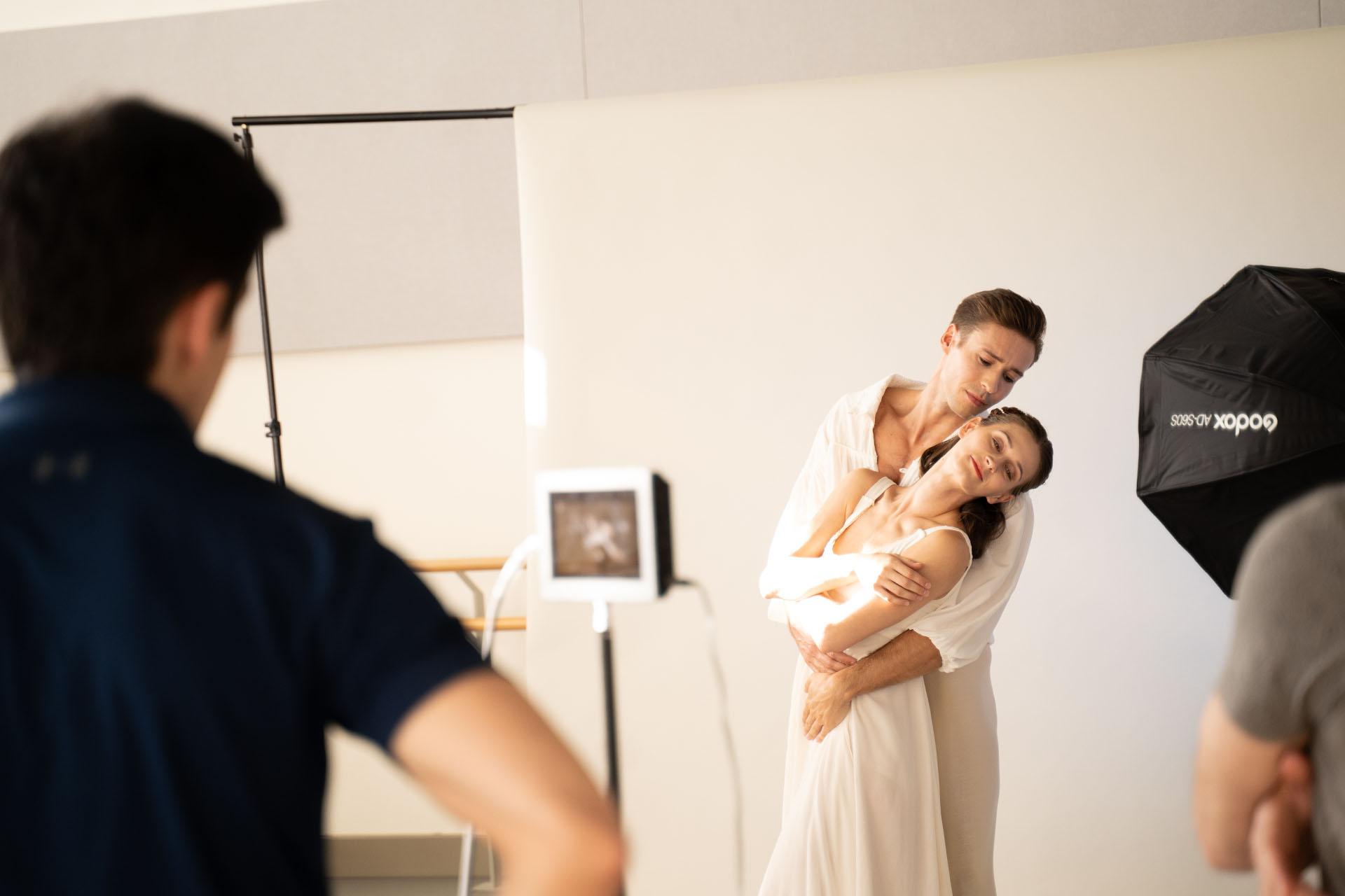 Two dancers in a classical pose for a photoshoot