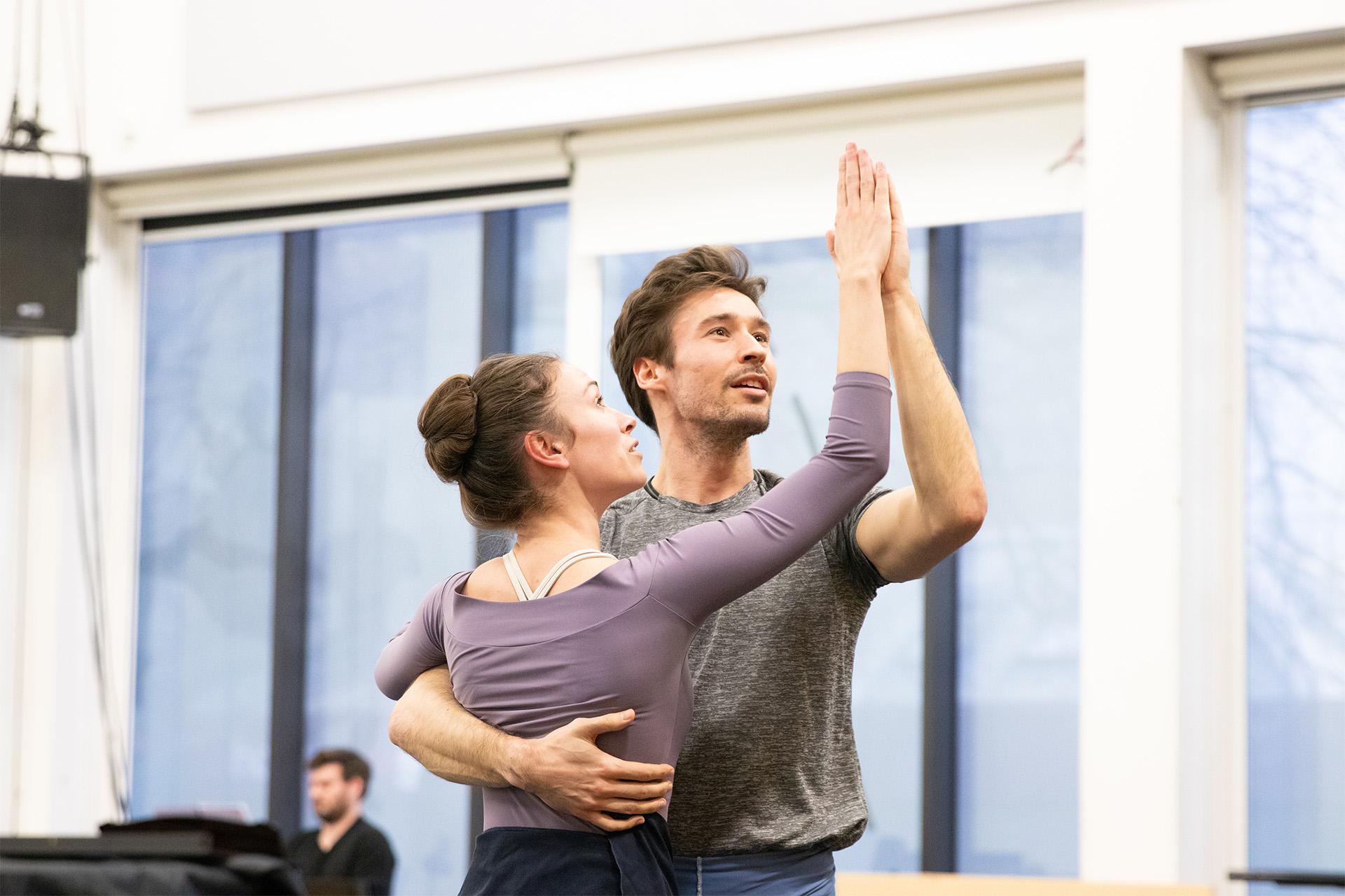 Two dancers stood with palms together