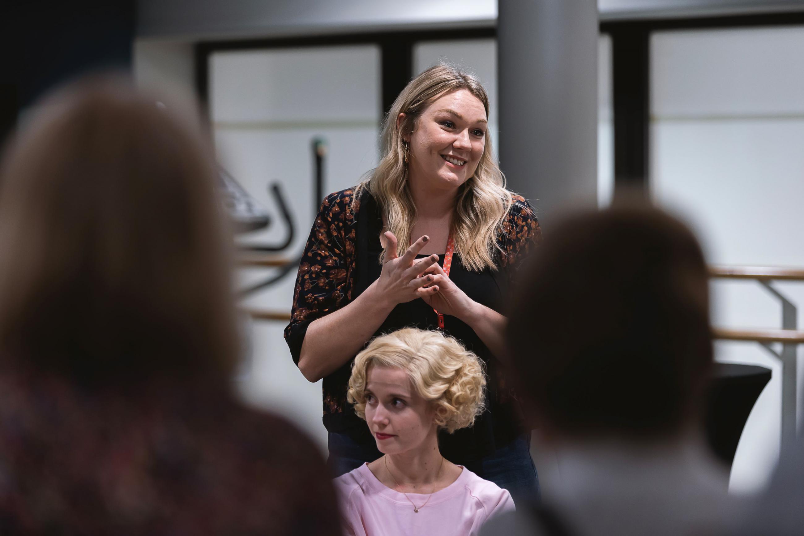 Harriet Rogers and Dominique Larose demonstrating a wig at a Benefactor Event. Photo Emily Nuttall