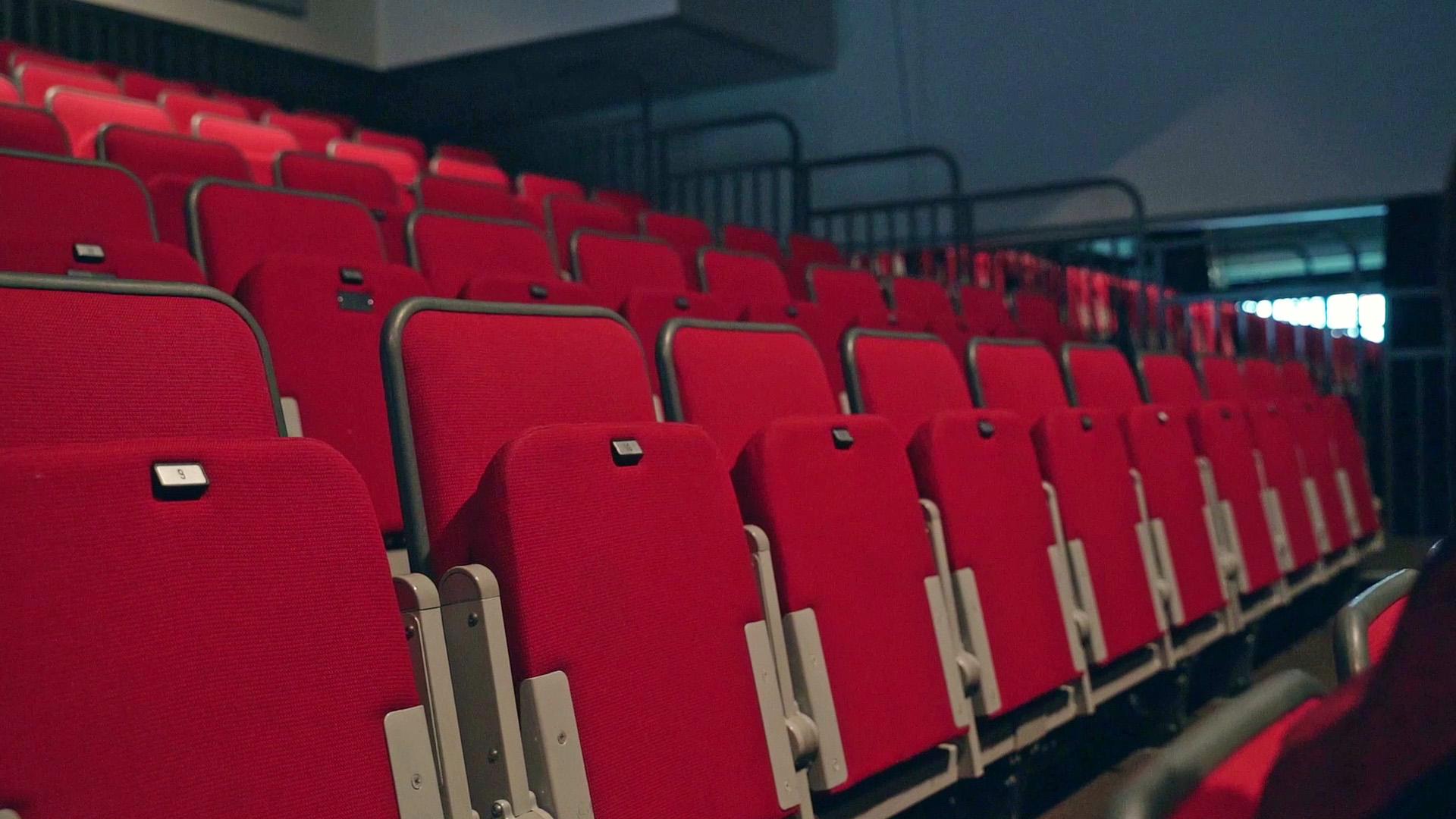 A close up of the seats in the Northern Ballet auditorium with the seats raised and the seat numbers visible