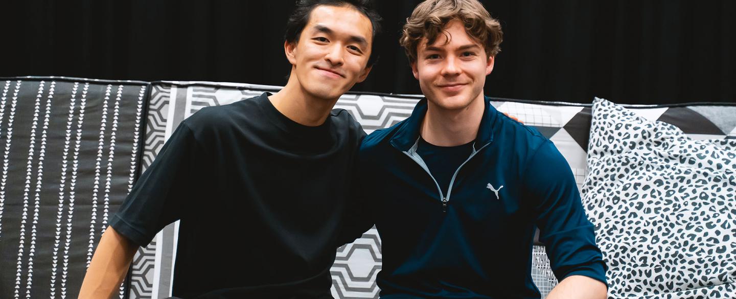 The two choreographers of Hansel & Gretel, George Liang and Harris Beattie, sat on the sofa that features in the ballet, both smiling directly at the camera