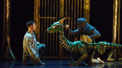 The dragon looks at Merlin, assessing him