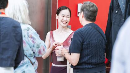 A smiling Northern Ballet dancer chatting with a supporter