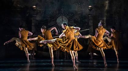 Army in gold velvet uniforms wielding pikes aggressively